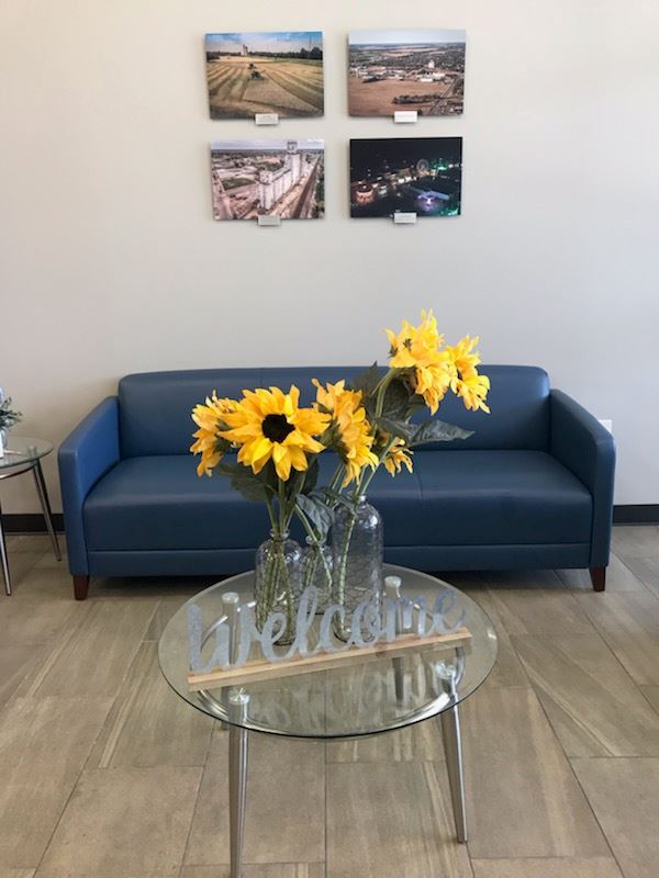 A table in the lobby displays a glass vase of sunflowers